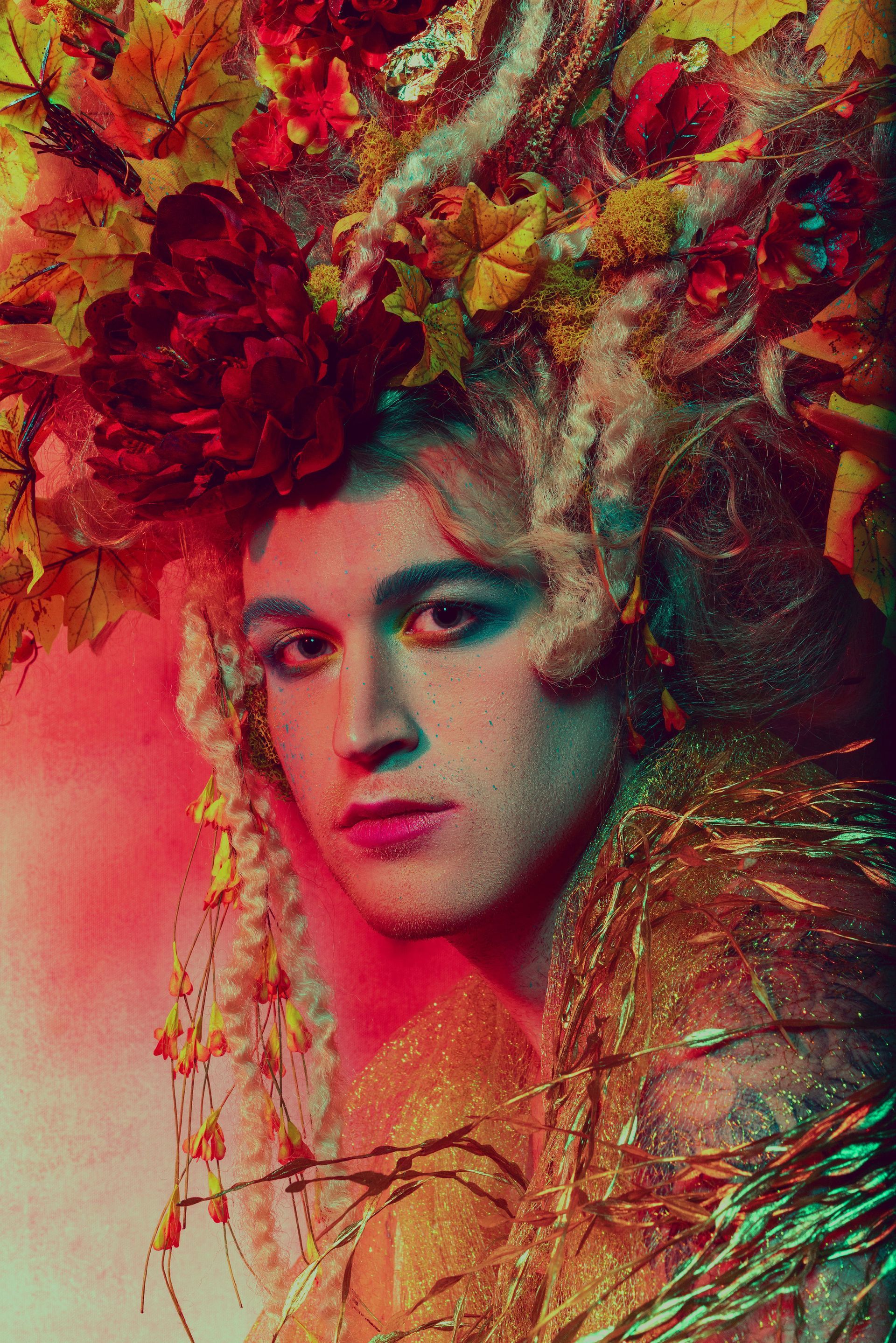 A close up of a person wearing a crown of flowers on their head for a fashion photo shoot.
