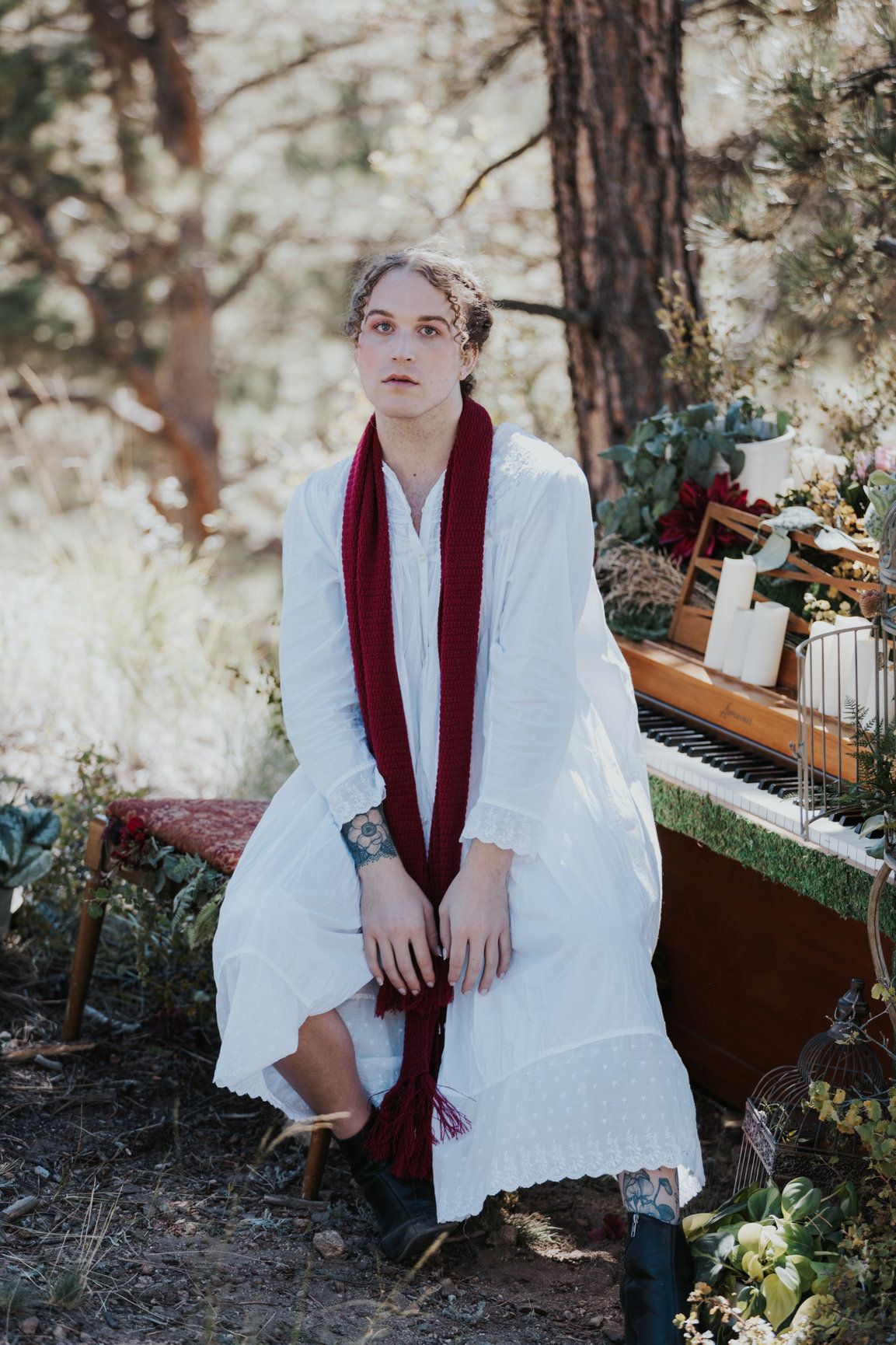 Scotty modeling  in a white night gown and red scarf for a Taylor Swift themed photoshoot