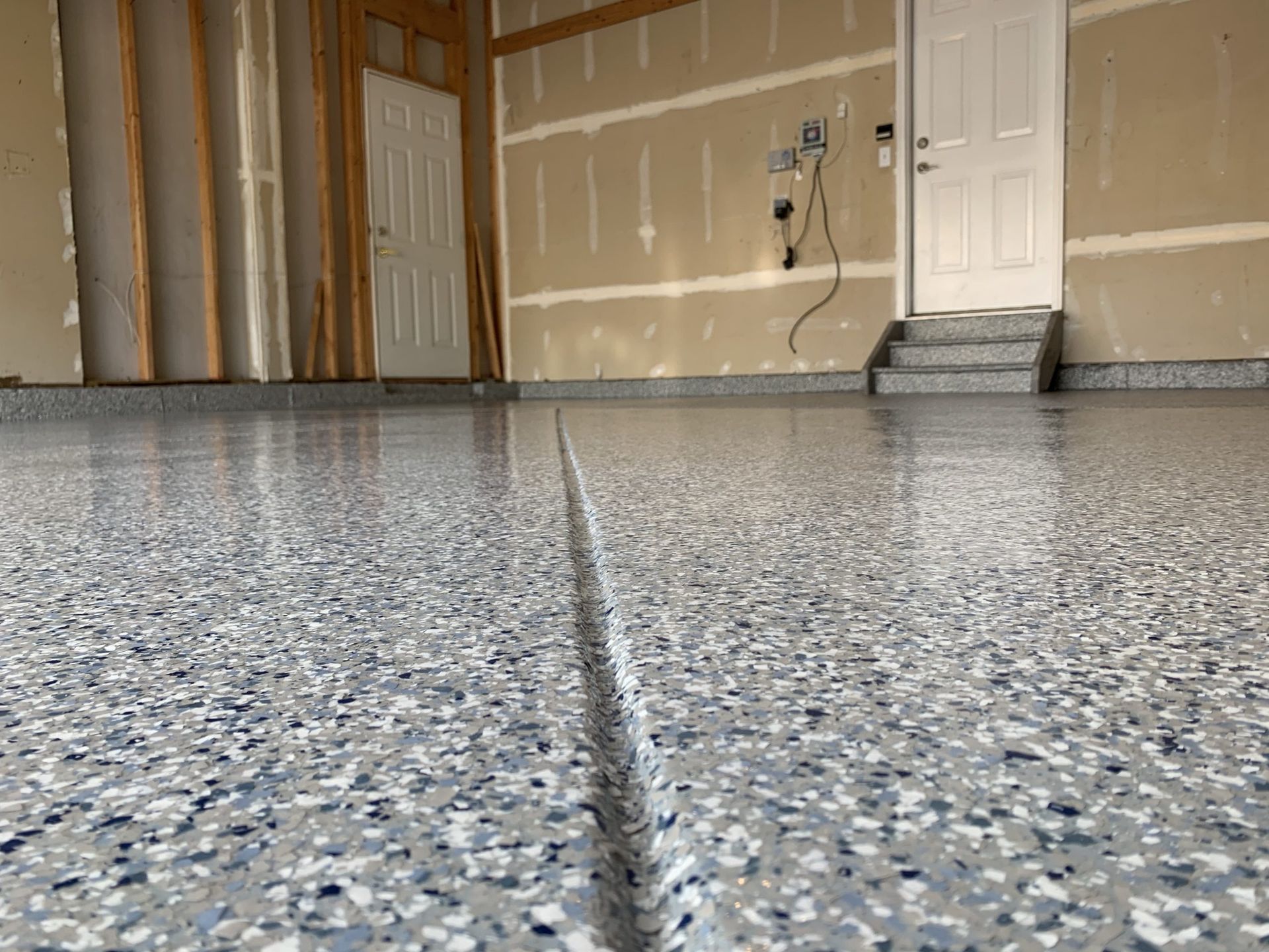 A garage with a concrete floor and a door.