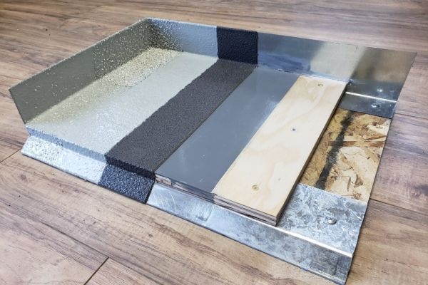 A piece of metal and wood is laying on a wooden floor.