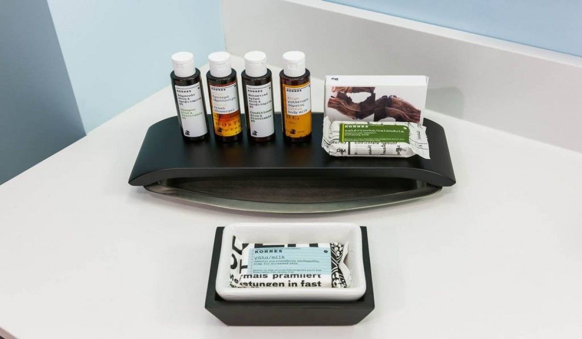 Assorted skincare products on a tray, with one package in the foreground on a white surface.