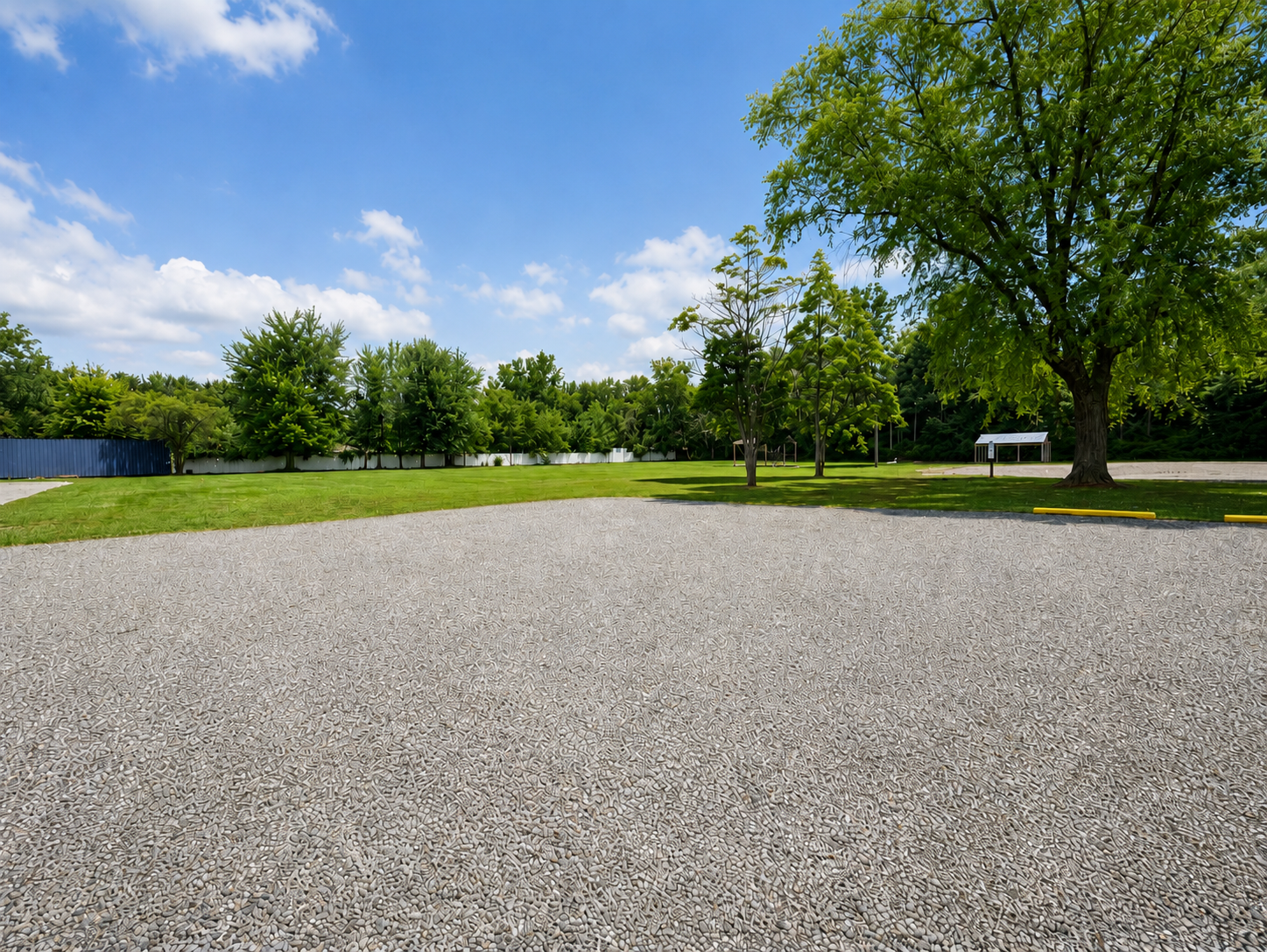 The large parking lot and grassy play space for the pavilions