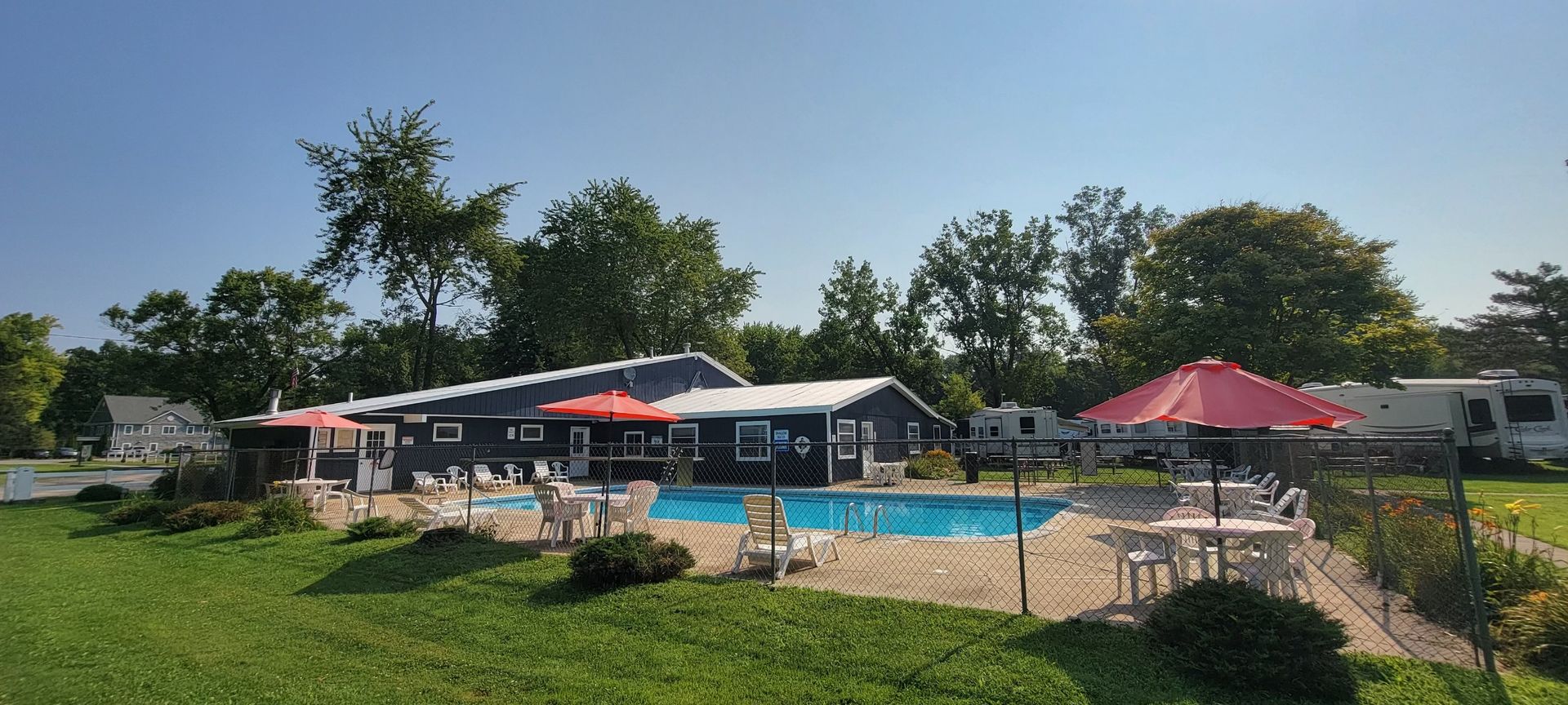 A large house with a swimming pool in front of it