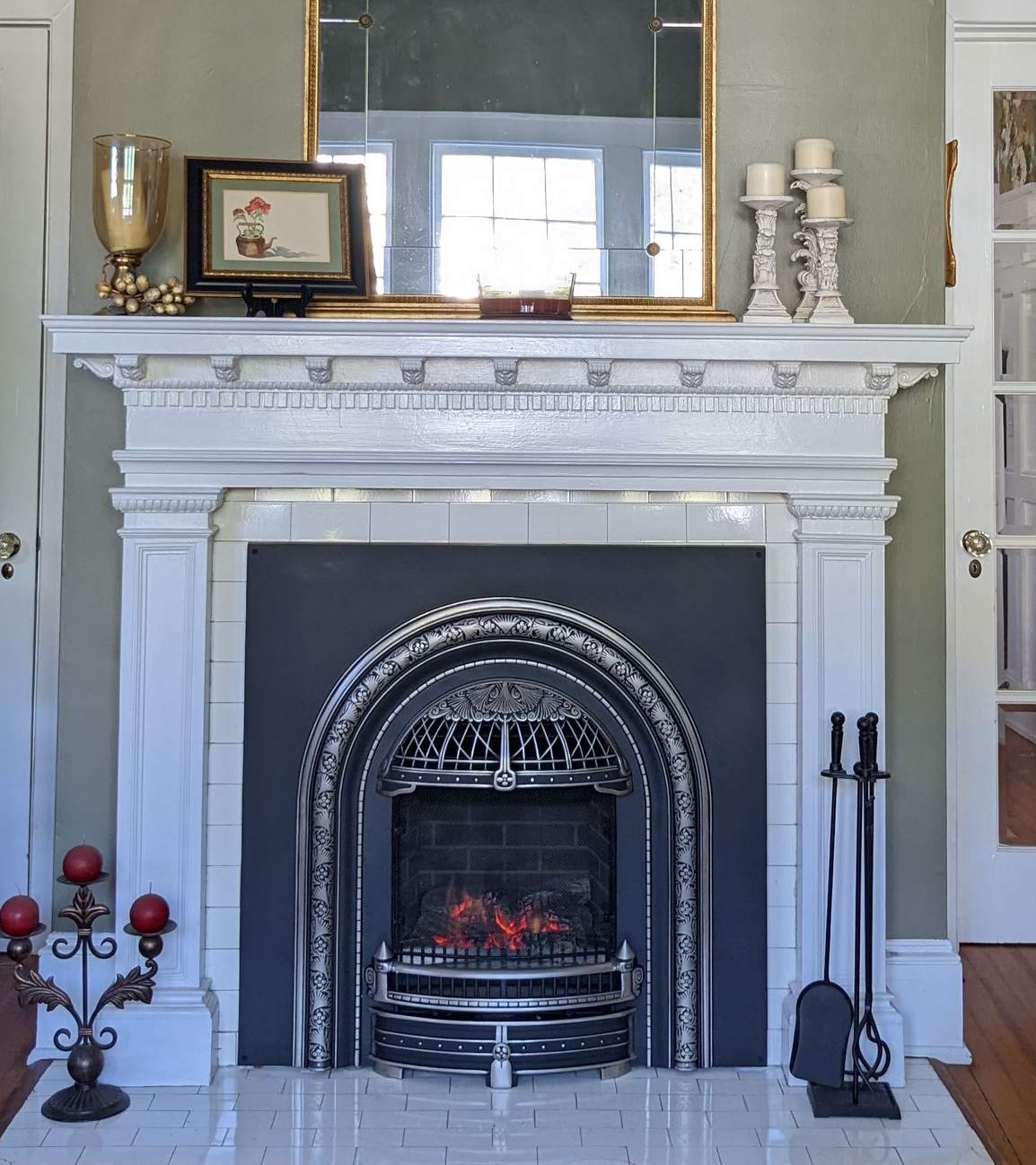 a living room with a fireplace and a mirror