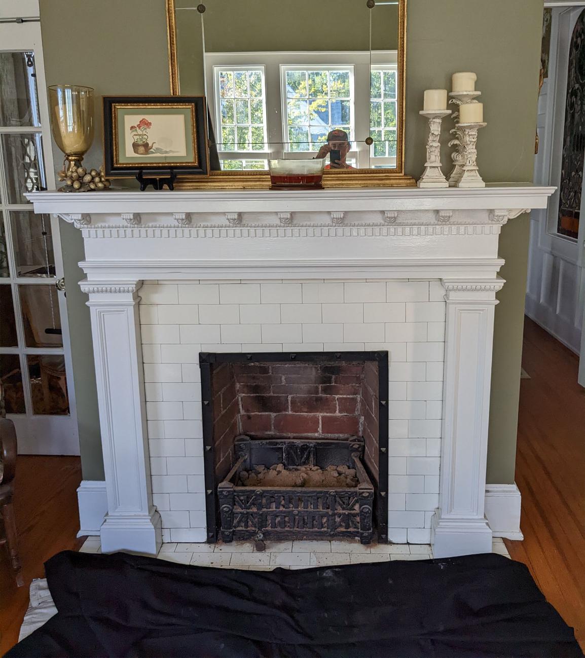 a living room with a fireplace and a mirror