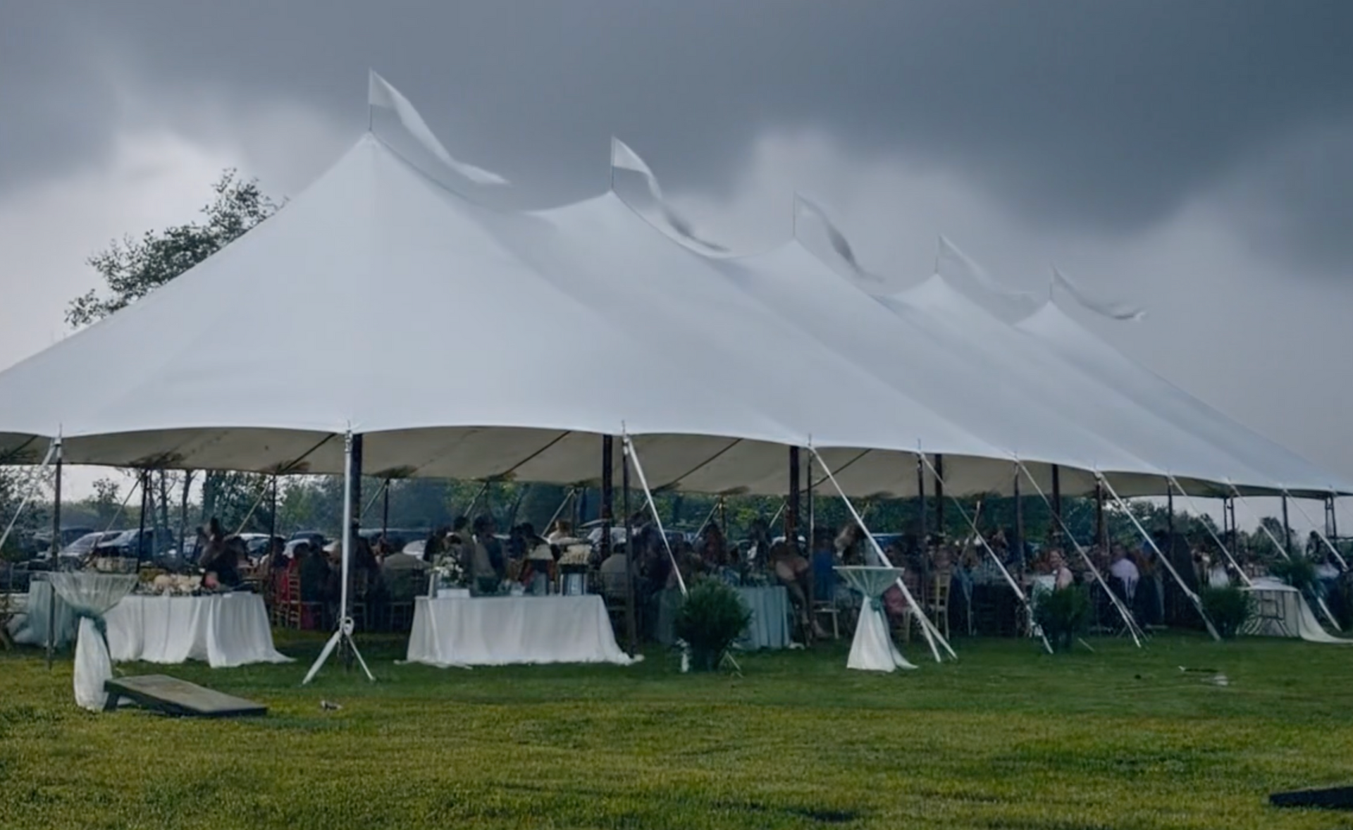 windy and raining on an event tent. 