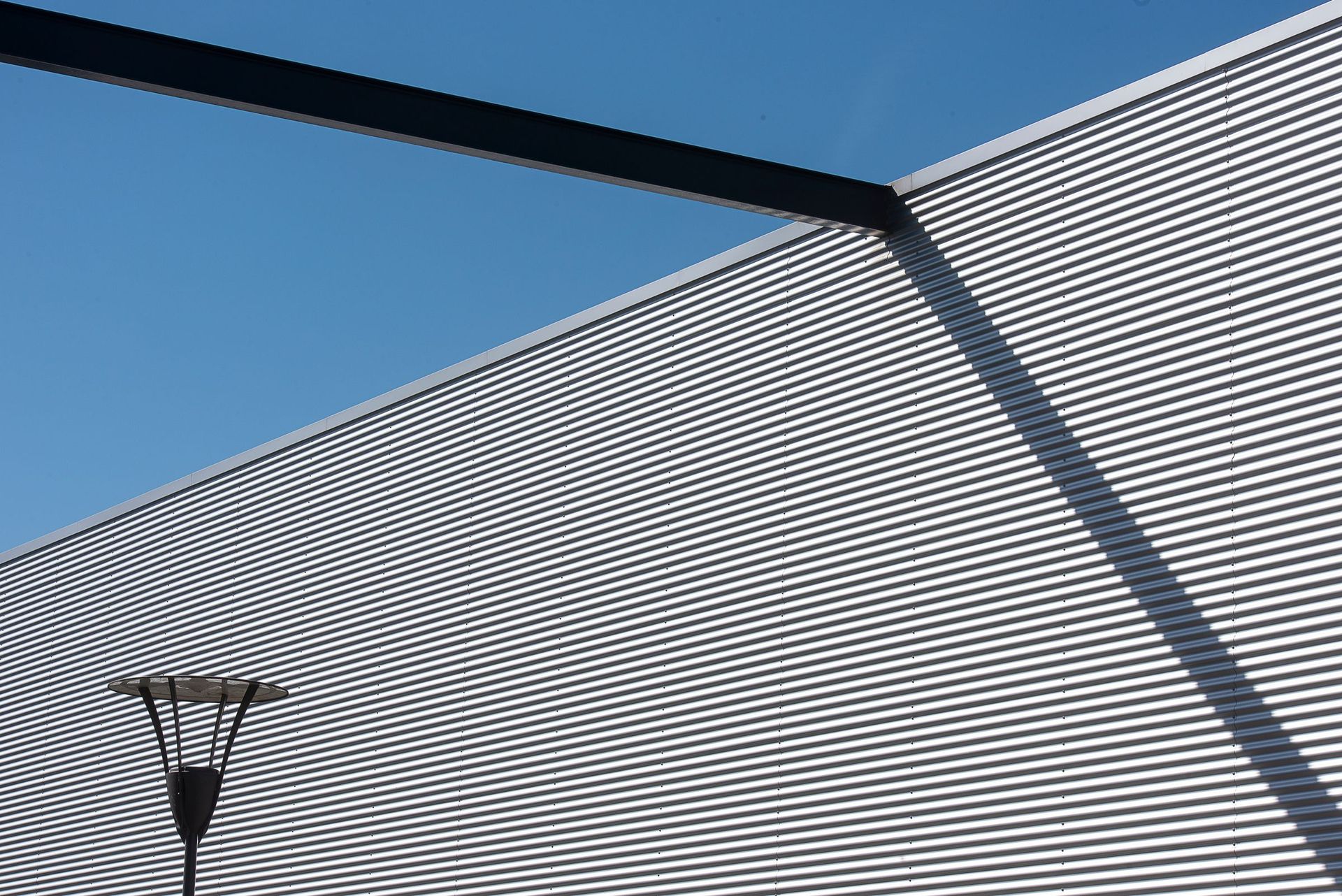 Corrugated metal wall against a blue sky