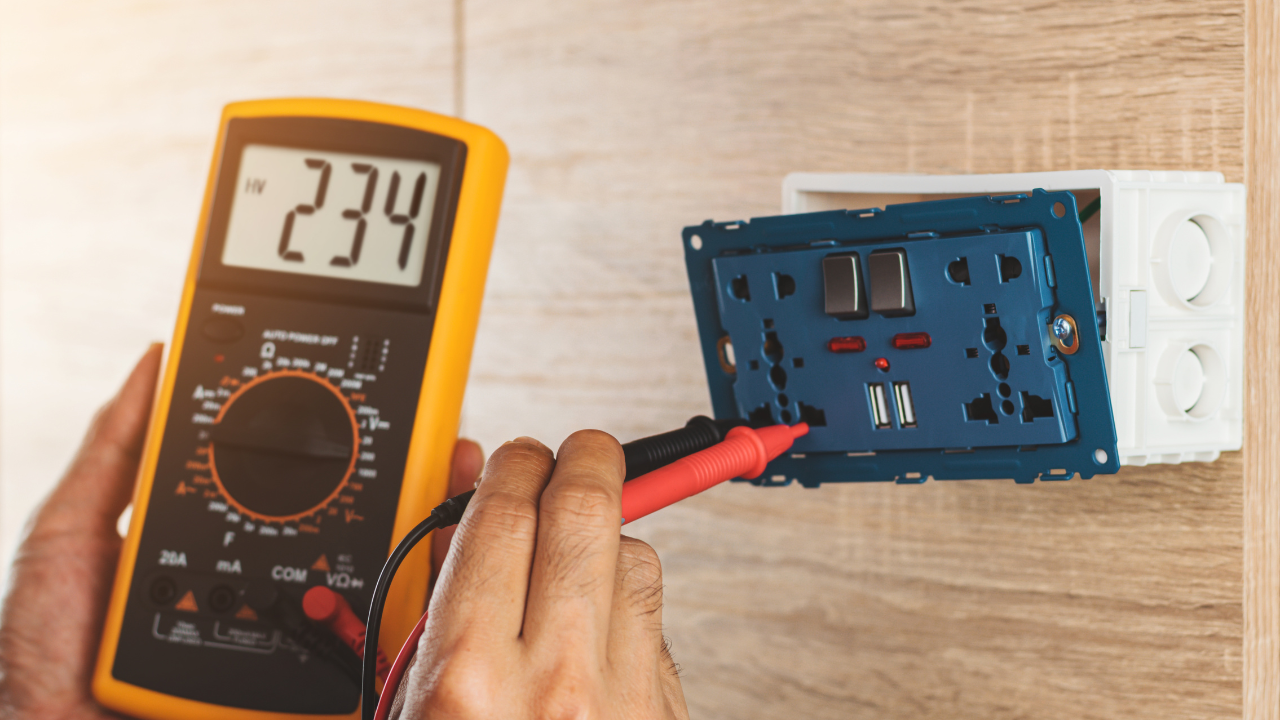 A person tests an electrical outlet with a multimeter, displaying a reading of 234.