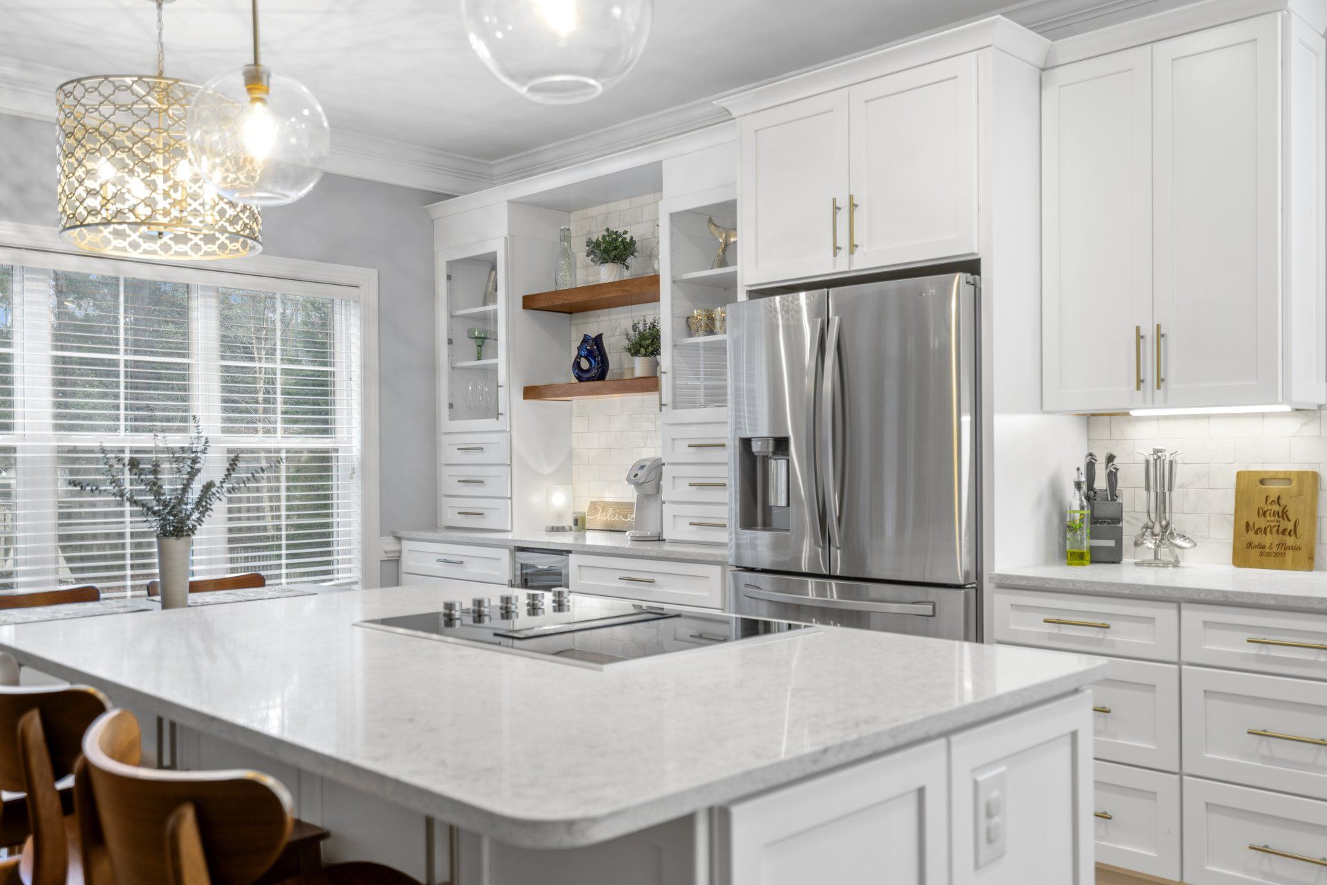 Kitchen remodel with island cooktop range and coffee bar area with floating shelves and tower cabinets for additional storage.