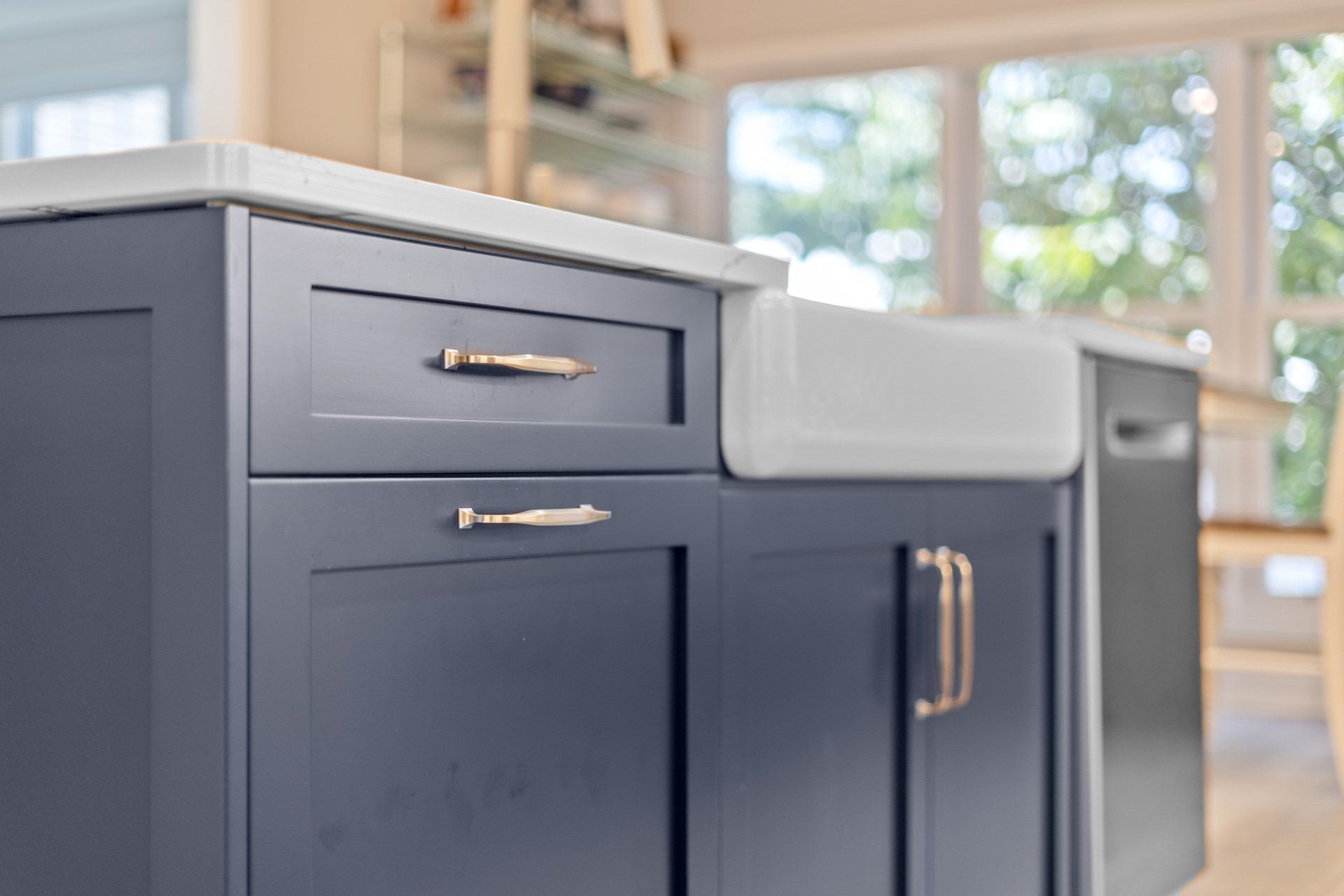 Navy blue kitchen island with farm house style sink.