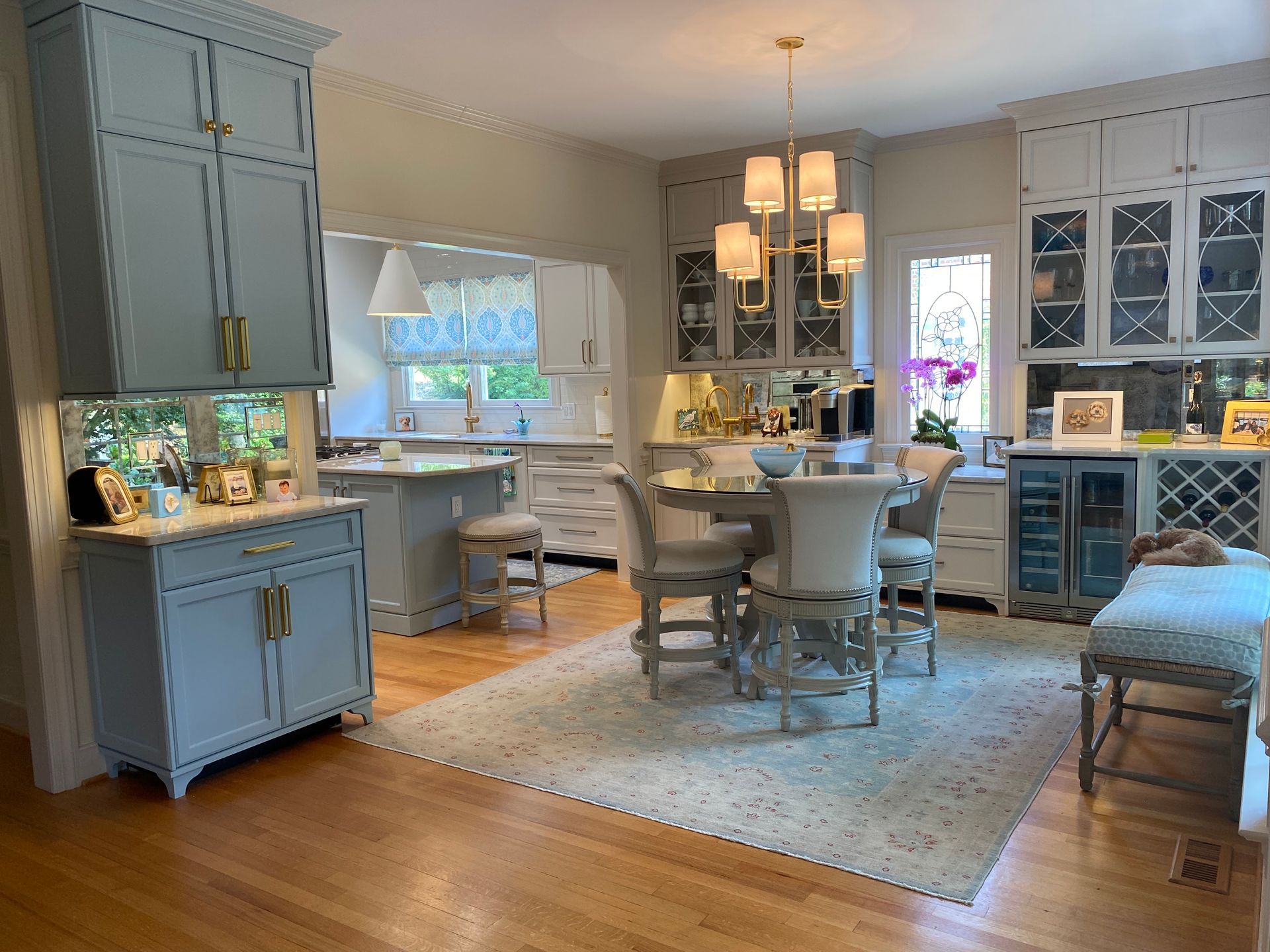 Dining room with coffee bar area and additional white and light blue cabinetry for storage.