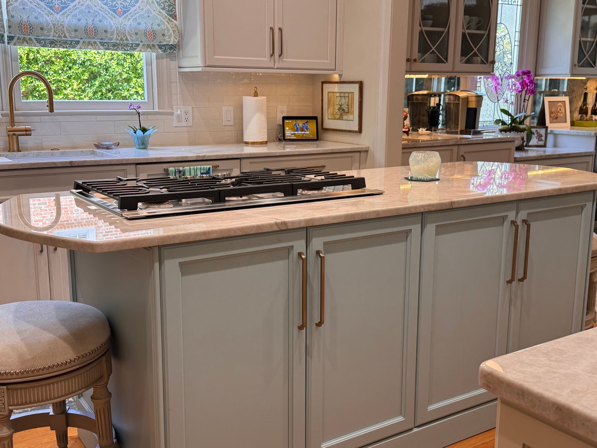 Light blue kitchen island with natural gas cooktop.