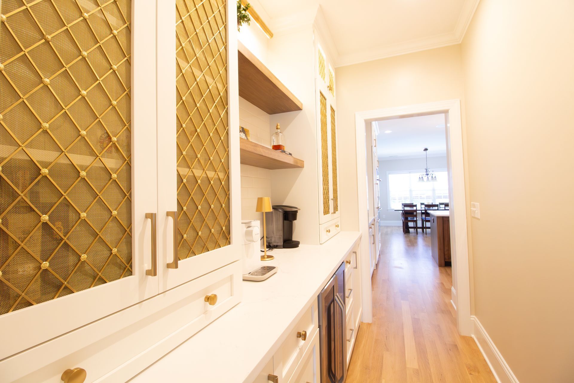 Imported gold wire cabinet fronts in coffee bar area of butlers pantry.