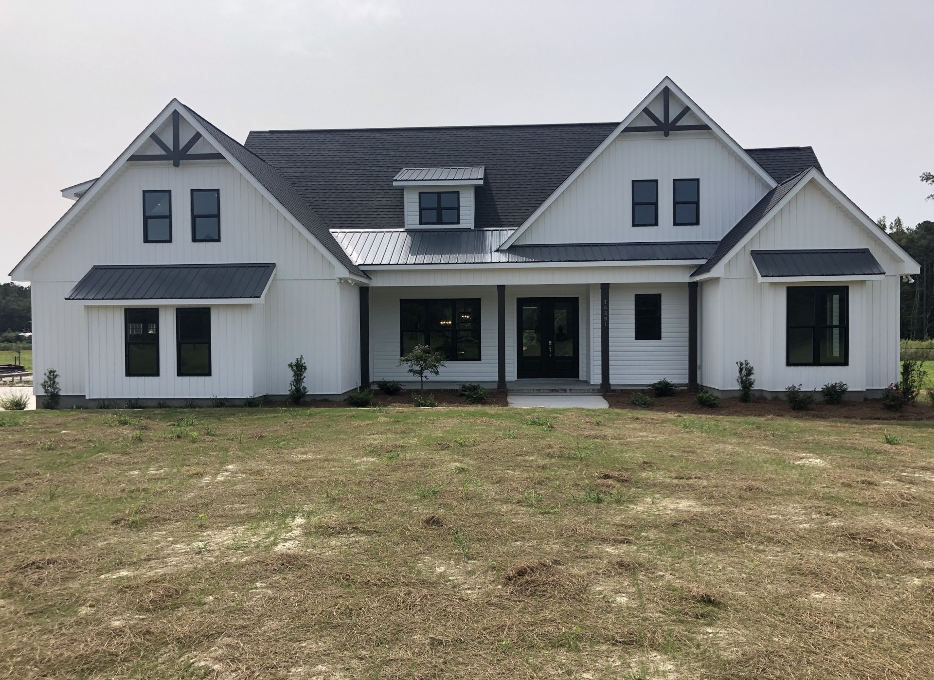 Exterior of white farmhouse style custom built home in Rocky Point, NC.