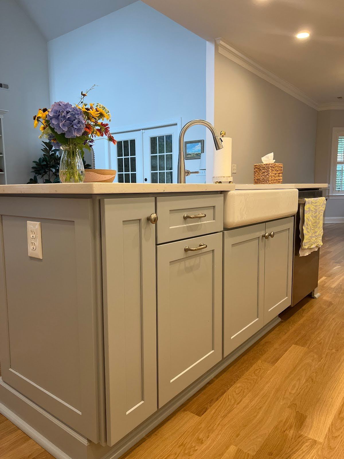 Coastal blue kitchen island with apron front farmhouse kitchen sink.