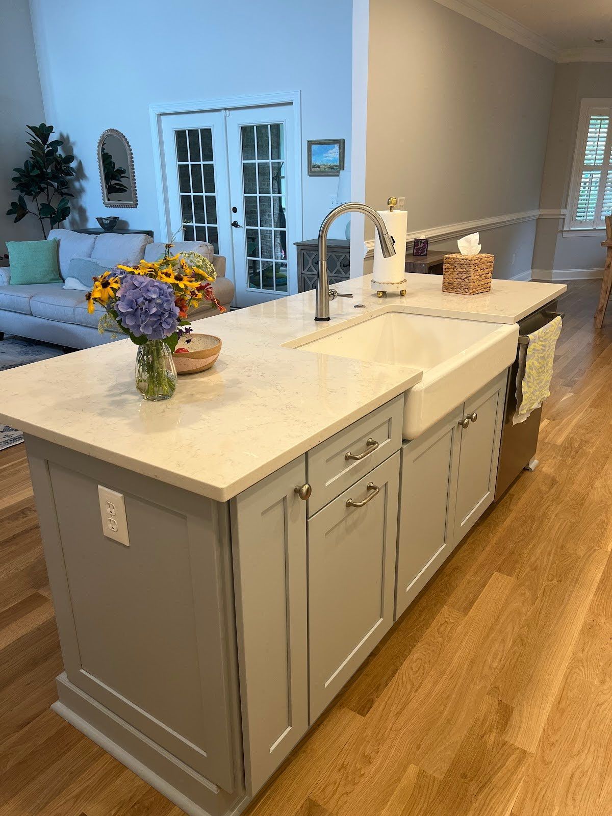 Apron front white farmhouse kitchen sink in coastal blue island.