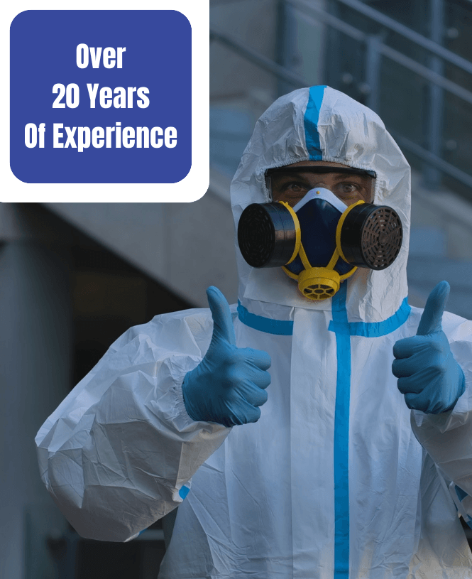 a man wearing a protective suit and mask is giving a thumbs up .
