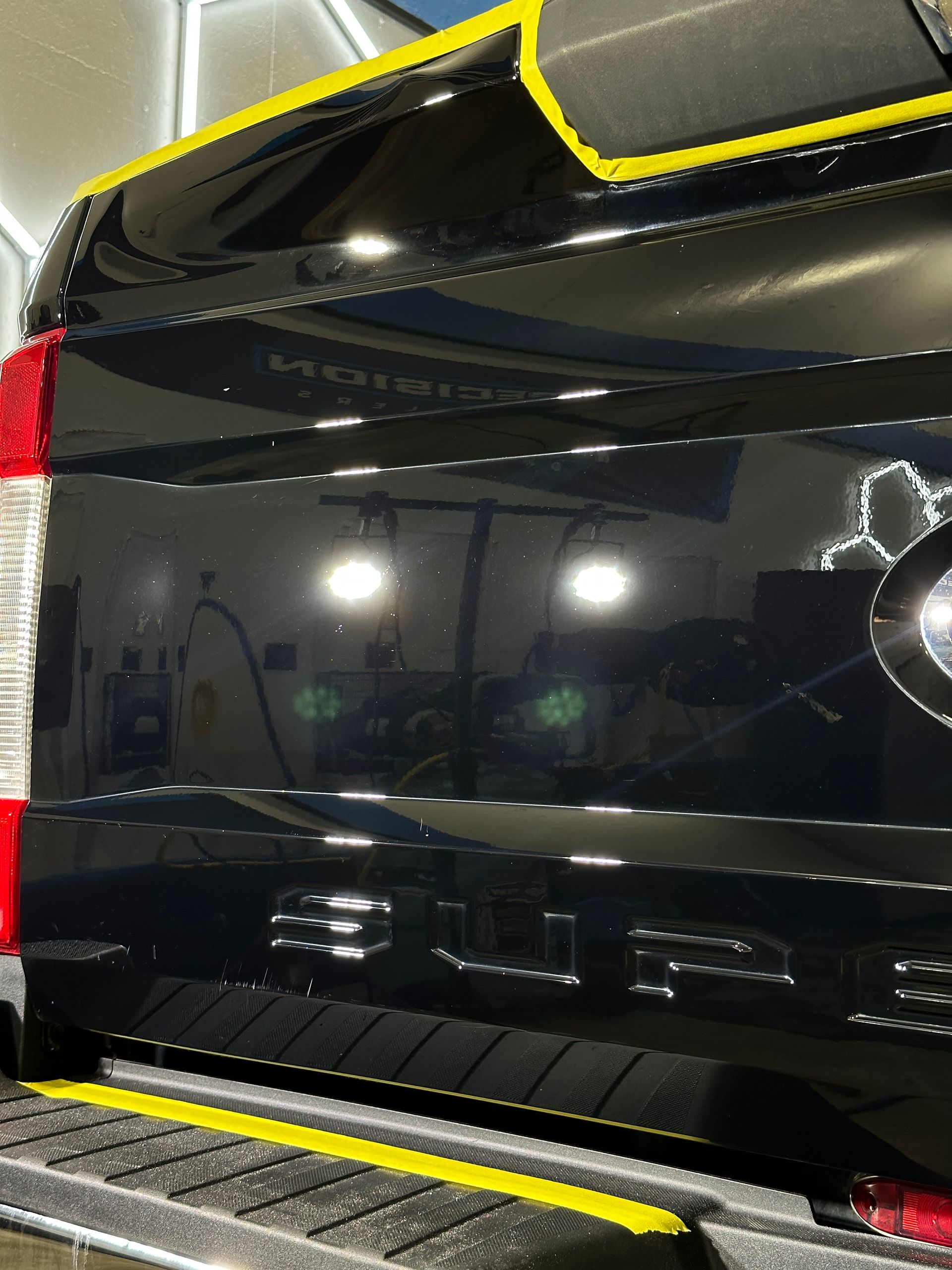 A close up of a black car with a bmw logo on the side