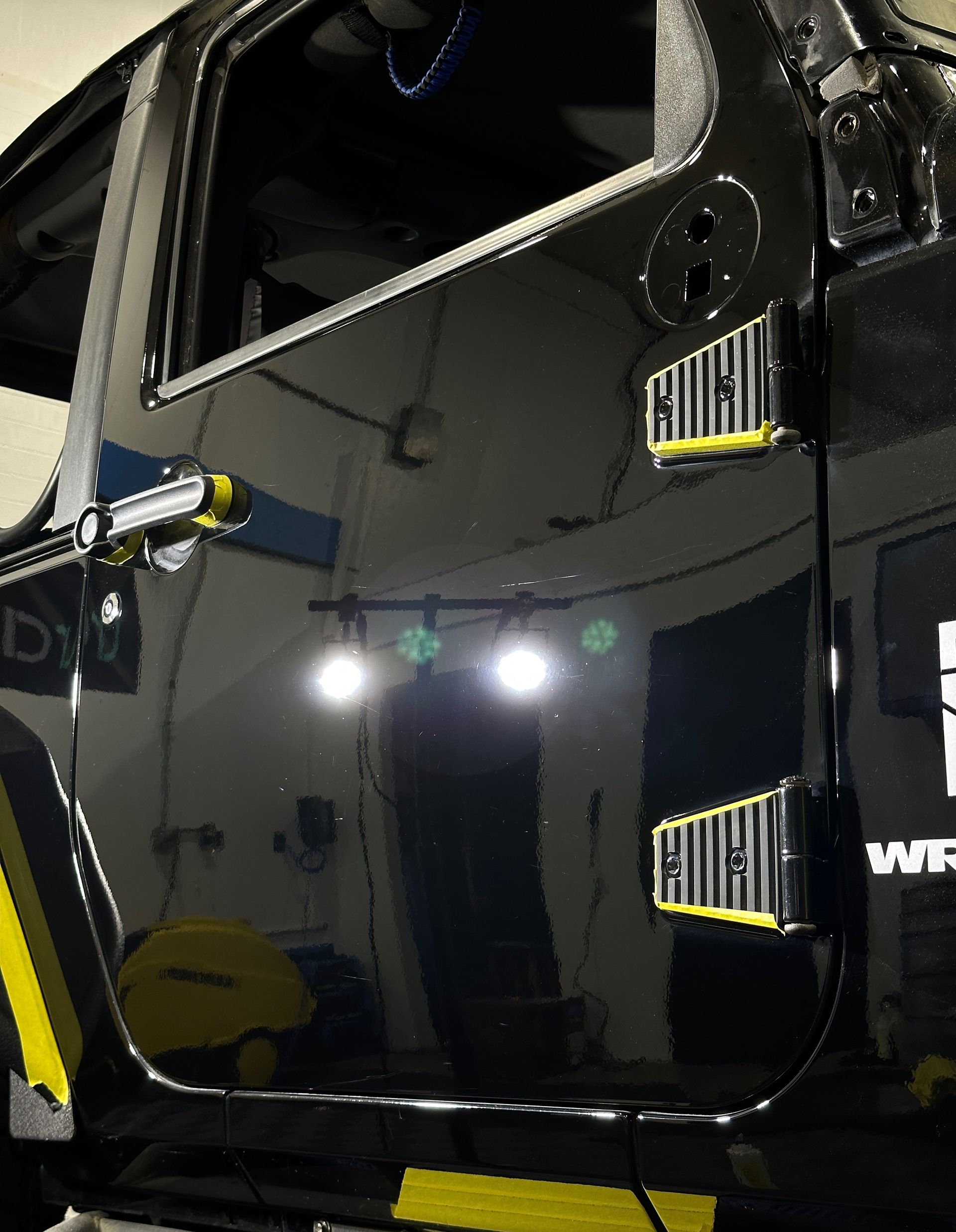 A black jeep with the word wrangler on the side