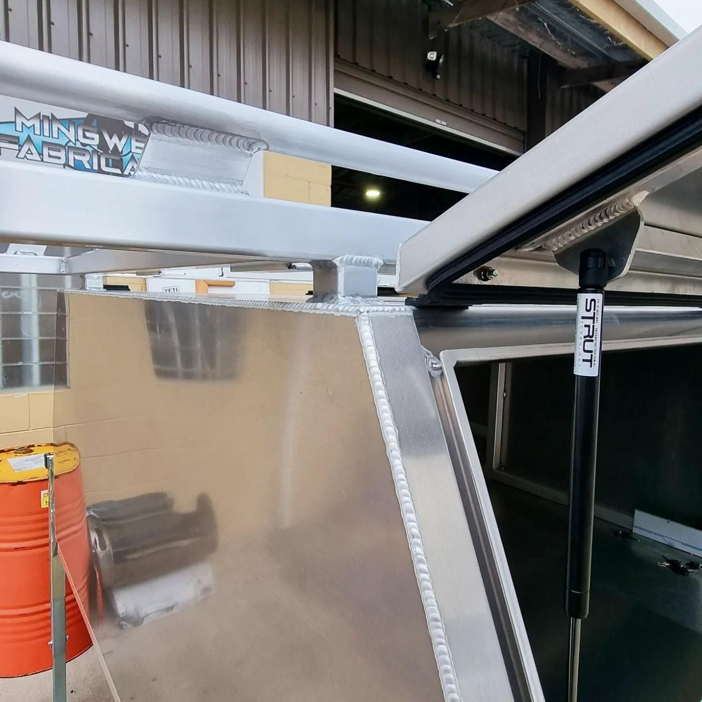 An Aluminum Canopy with A Sign that Says Hung We Acrylic — Mingweld Fabrication in Bungalow, QLD 
