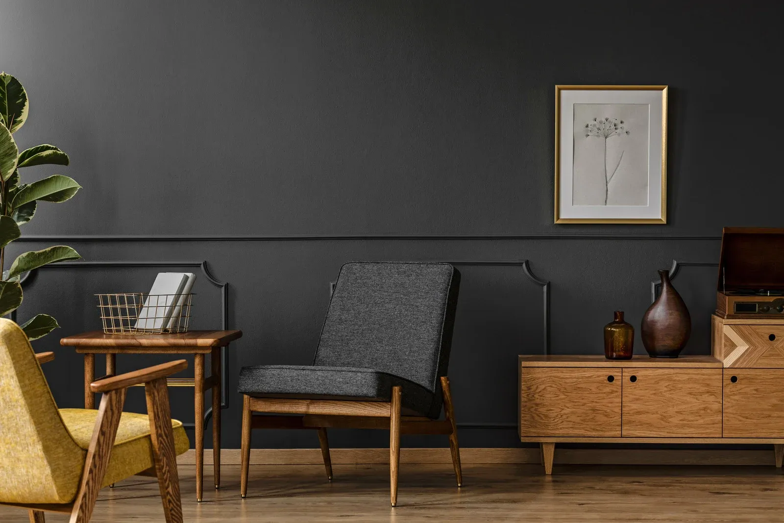 Modern living room with dark gray walls, wooden furniture, chair, and cabinet decor