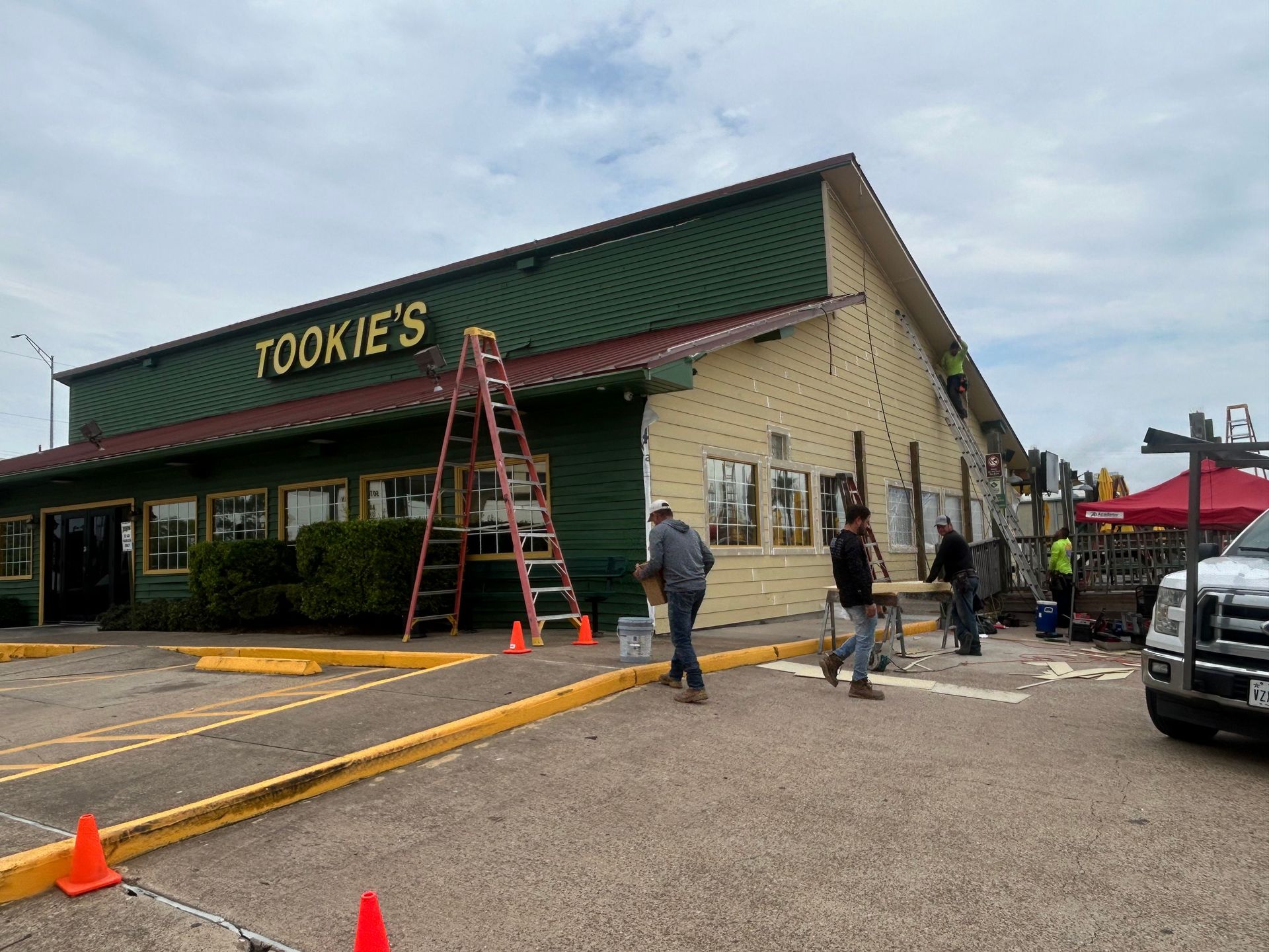 Exterior of Tookie's restaurant during construction. Men are working around the building.