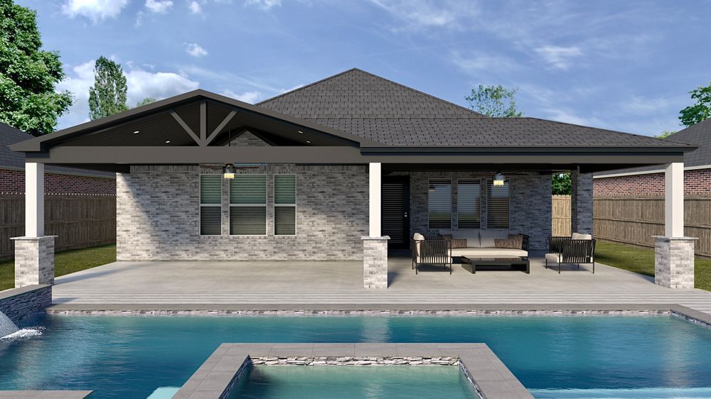 A brick home with a pool; gray roof, patio with outdoor furniture.