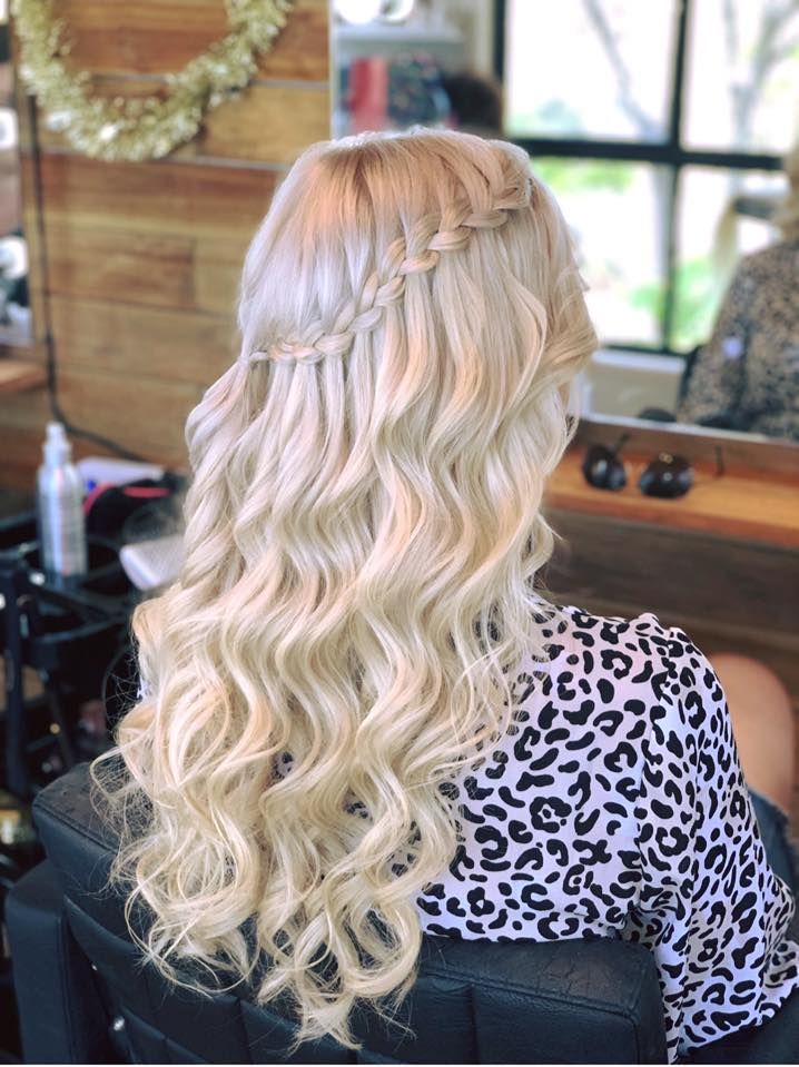 A Woman is Sitting in a Chair With Her Hair in a Waterfall Braid — Tree House Salon In Nerang, QLD