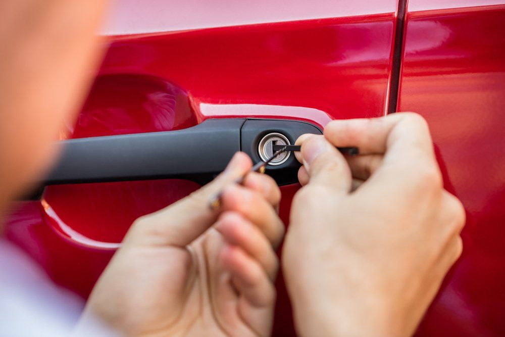 Hand Opening Car Door With Lockpicker — Locksmiths in Townsville, QLD