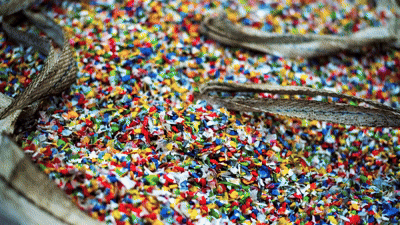 shredded recycled plastic bottle caps, illustrating the processing stage used to create Brava composite roofing materials.