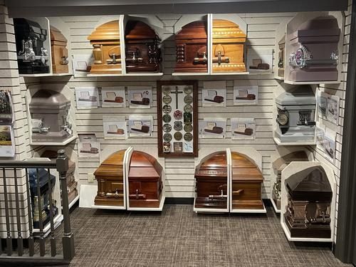 Shelves of decorative birdcages and small pet enclosures in a store aisle