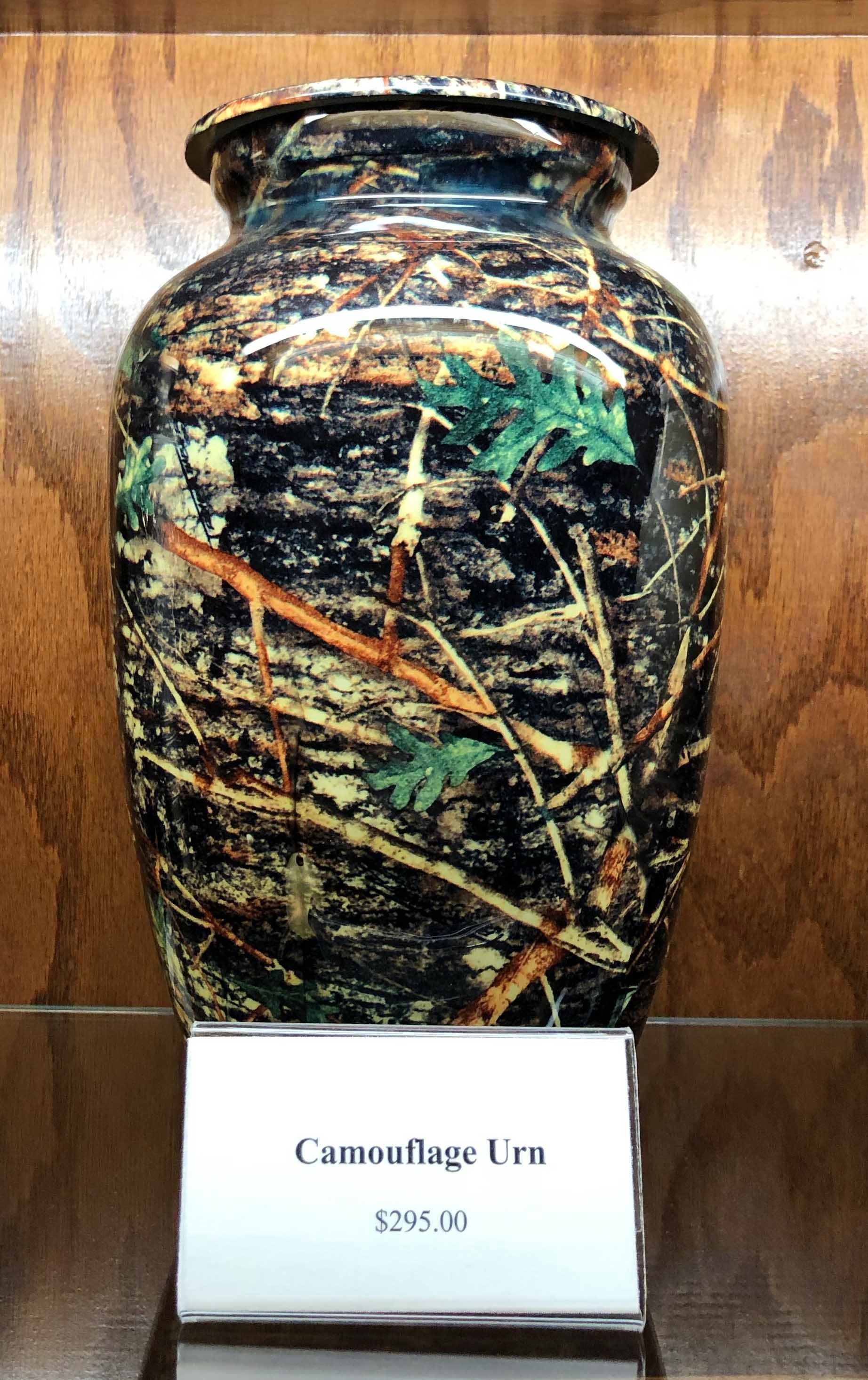 Decorative ceramic vase with dark multicolor abstract pattern on a display stand