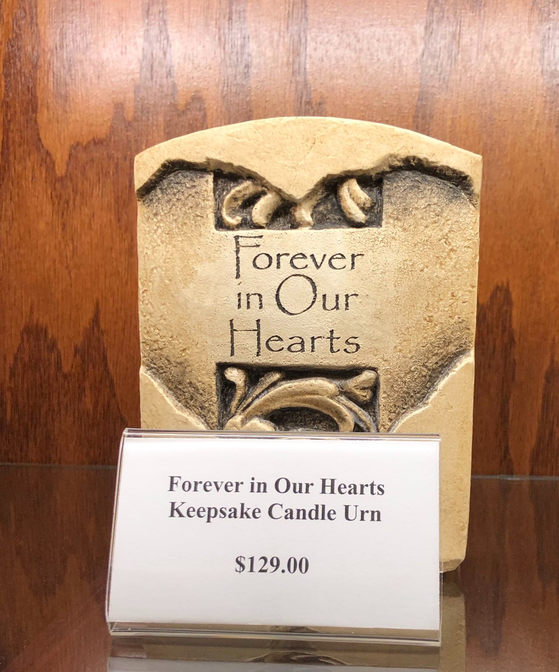 “Forever in Our Hearts” keepsake candle urn on display with price tag, $129.00