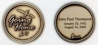 Two round memorial keepsakes: one says “Going Home,” the other “John Paul Thompson” with dates.