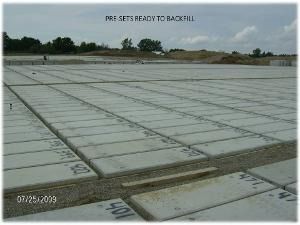 Concrete slabs laid across a construction site under a cloudy sky