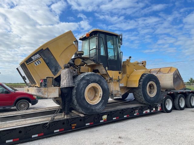 A bulldozer is sitting on top of a trailer.