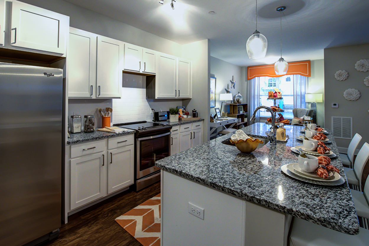 A kitchen with stainless steel appliances and granite counter tops.