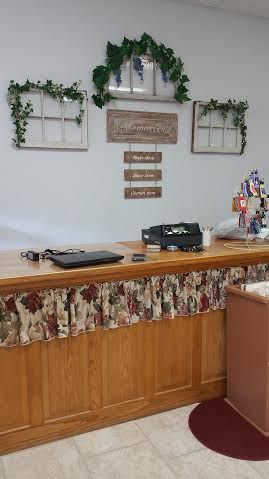 A wooden counter in a room with a laptop on it.