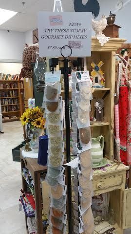 A store filled with lots of items and a sign on a pole.
