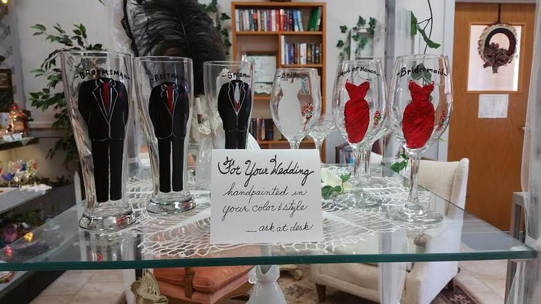 A glass table with wine glasses on it and a sign that says 