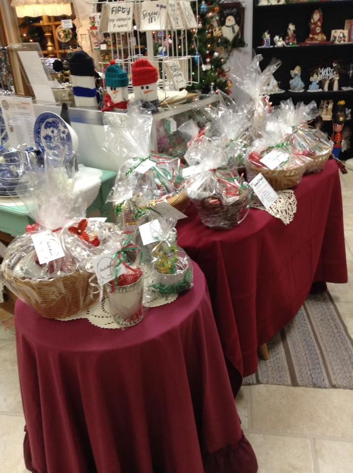A table with a red table cloth and baskets on it