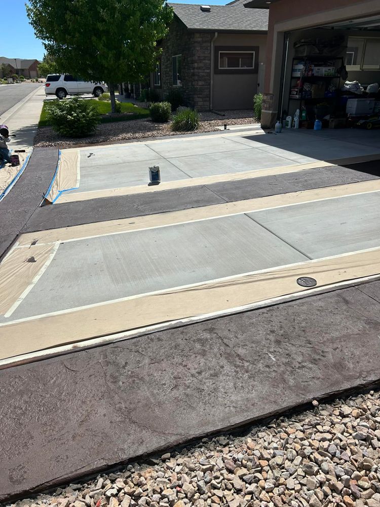Concrete driveway with a decorative border and painted sections.