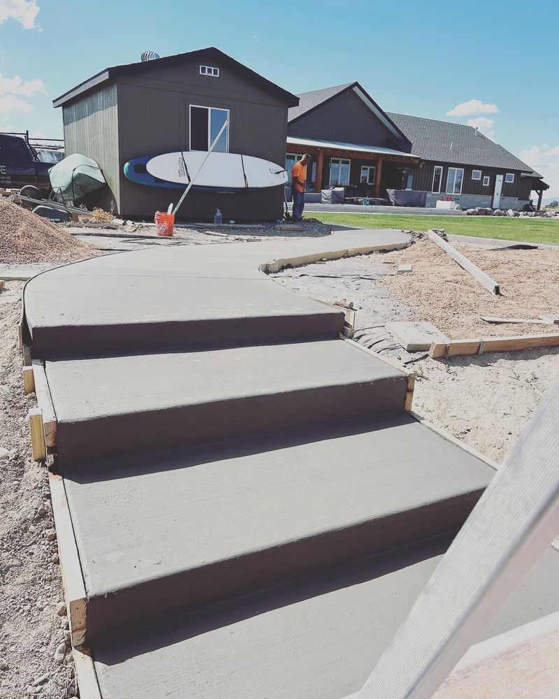 Concrete steps leading to a house under construction.