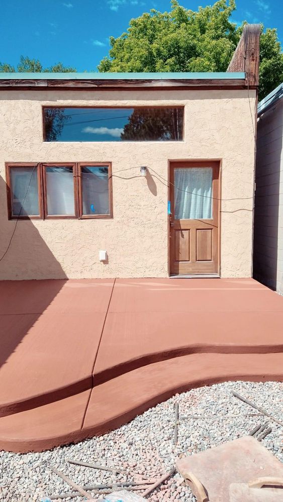 Tan building with a red patio.