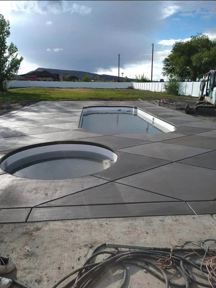 Concrete deck with two sunken areas, one round, one rectangular; cloudy sky.