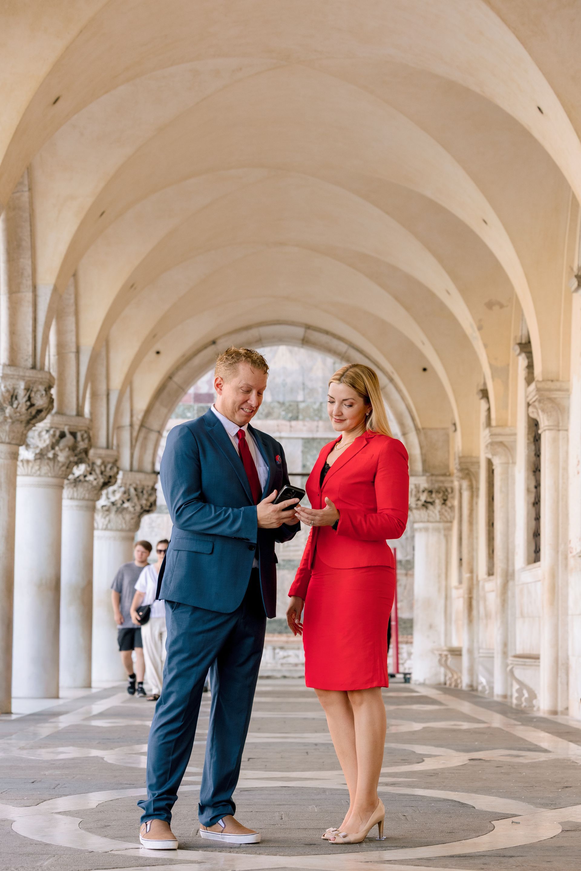 Florida bankruptcy attorneys Veronica Batt and Adrian Lynn of Lynn Law Group reviewing a phone together outdoors, serving student loan borrowers in Cape Coral and Fort Myers. Copy
