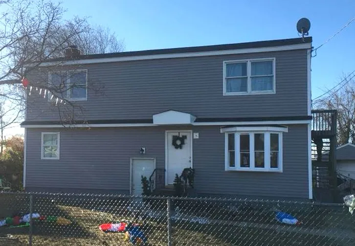 A house with a chain link fence in front of it