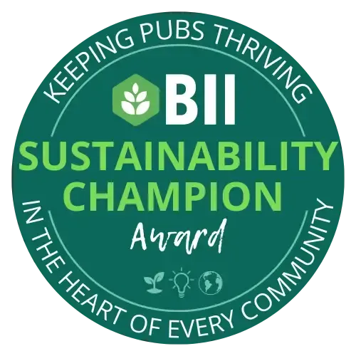 Green circular BII Sustainability Champion Award badge with leaf icon and “Keeping pubs thriving” text