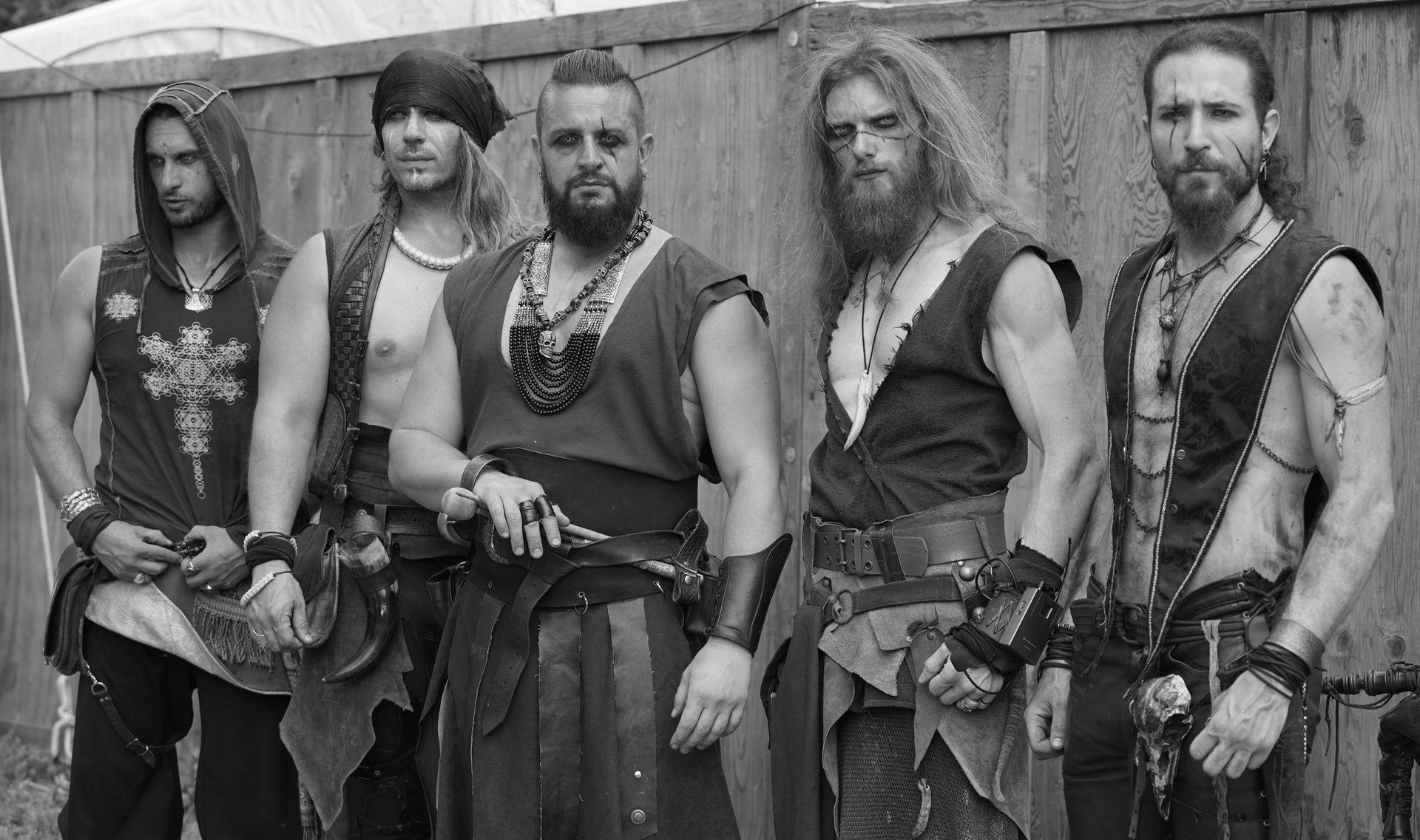 A group of men are standing next to each other in a black and white photo.