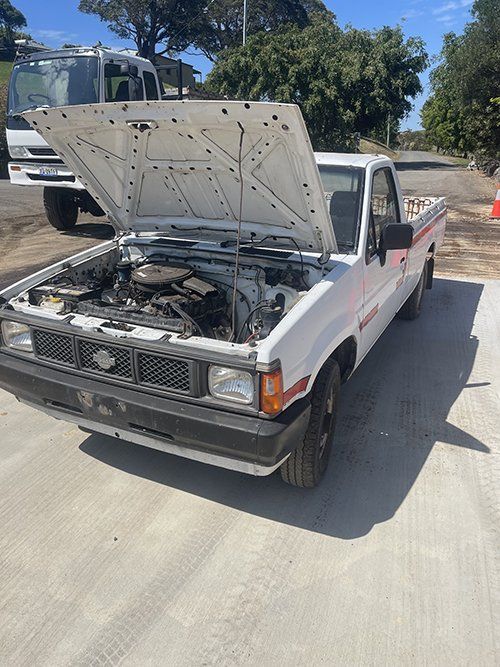 A White Truck With The Hood Up Is Parked On The Side Of The Road — East Coast Metal Recycling In Tugun, QLD